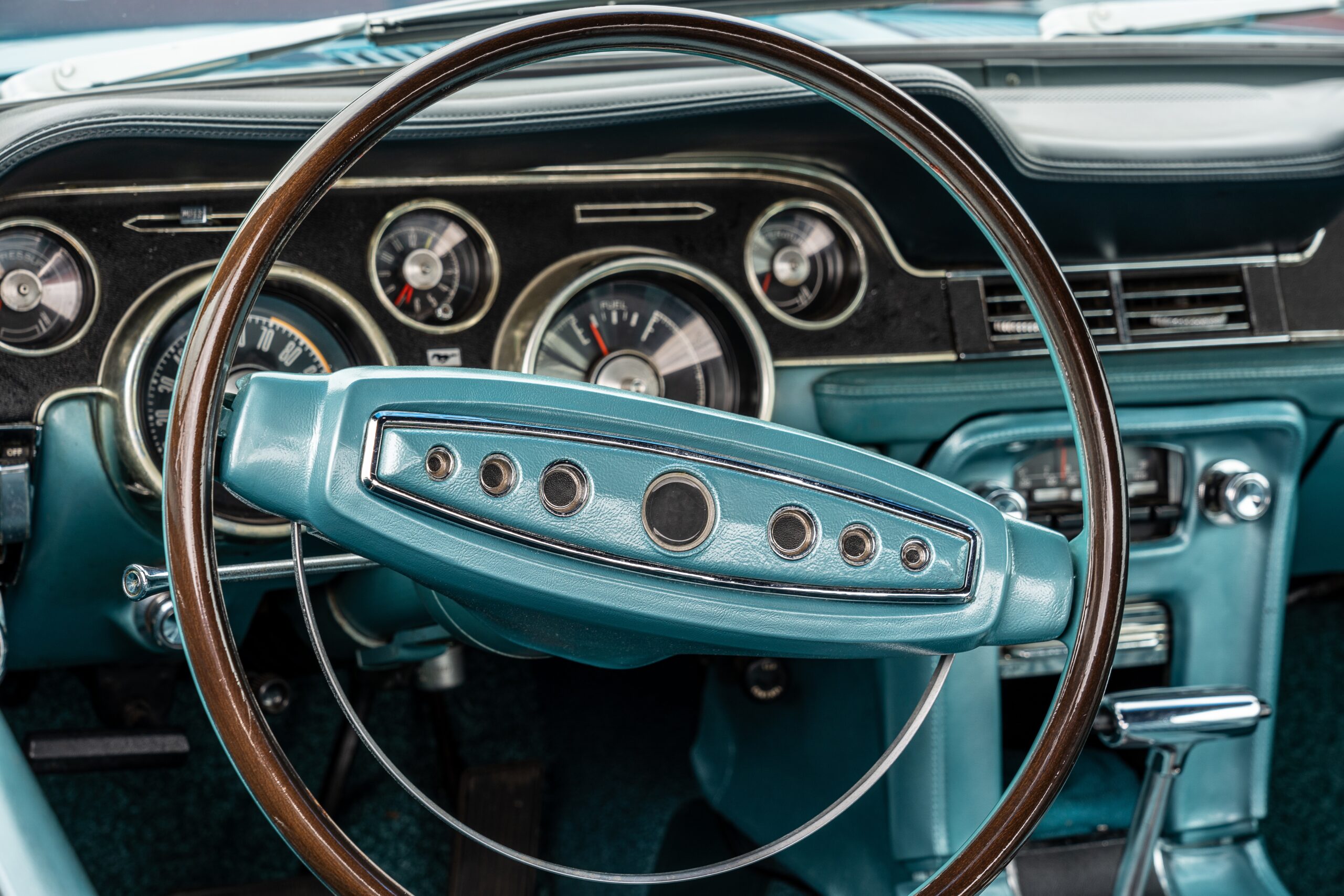 Closeup shot of a turquoise interior of a car, including the steering wheel Reifen-m+s